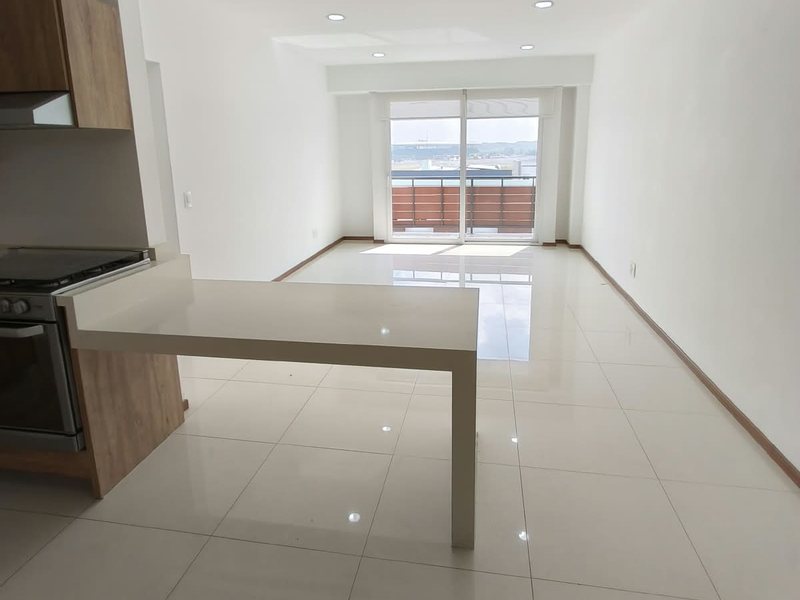 Sala y comedor del departamento de 2 recámaras con ventanal al balcón